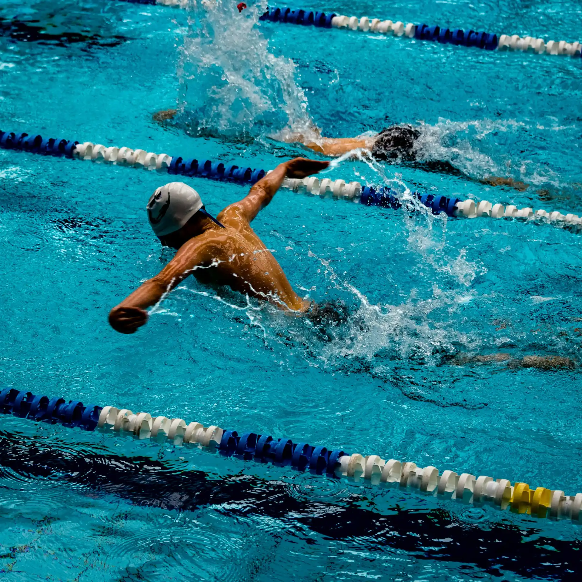 A swimmer mid-stroke in open water.