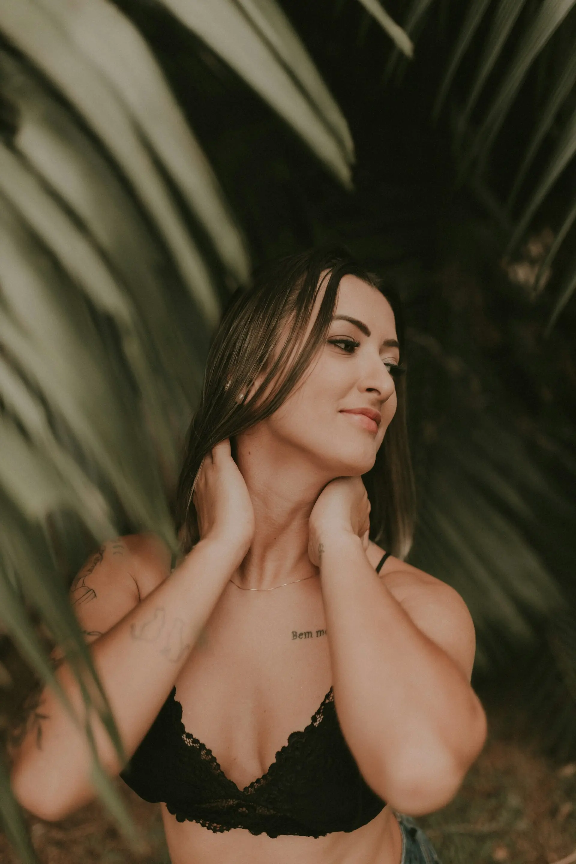 A woman in a black soft bra top.