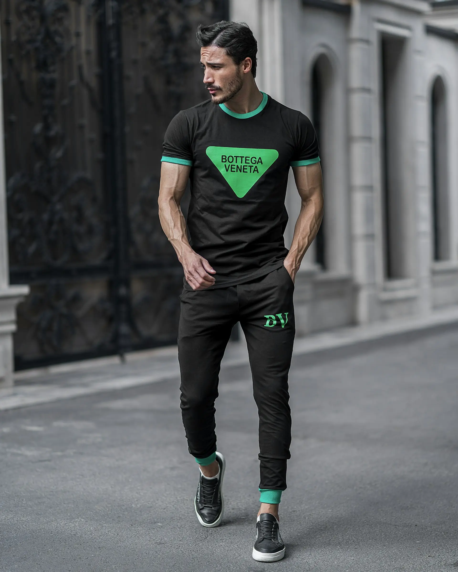 A man in a green shirt and black pants.