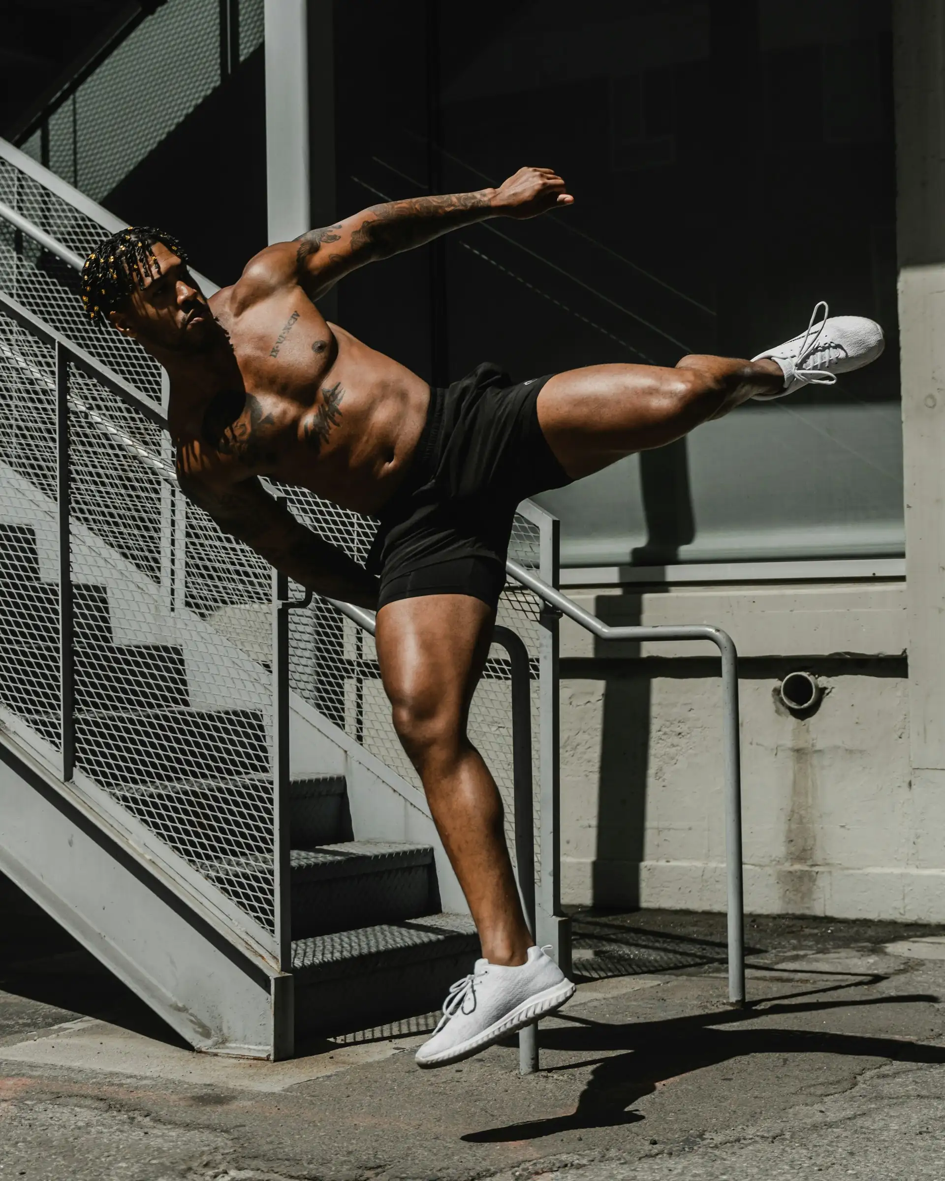 A man in black shorts holding a push-up.