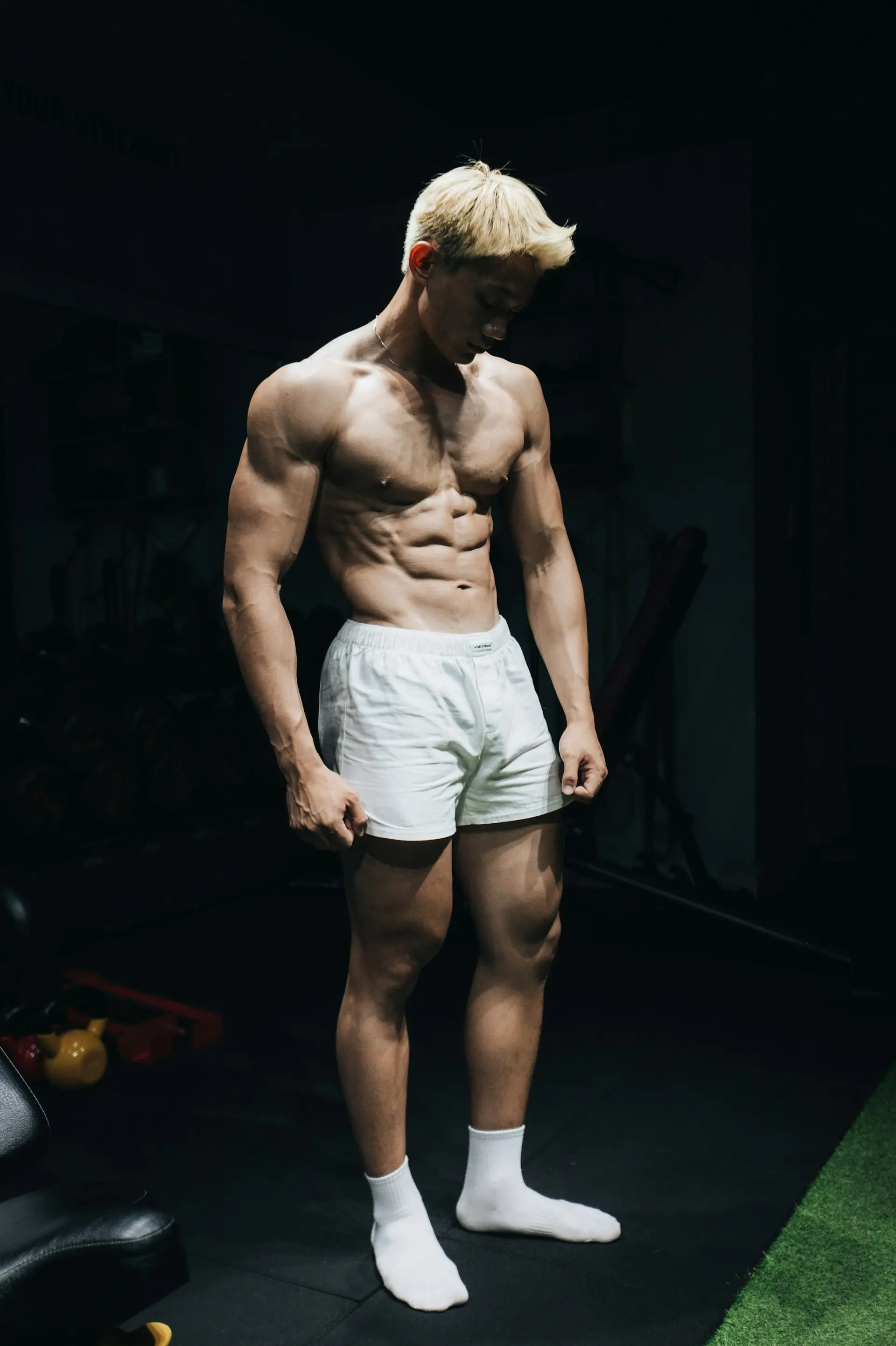 A lifter standing in a gym between sets.