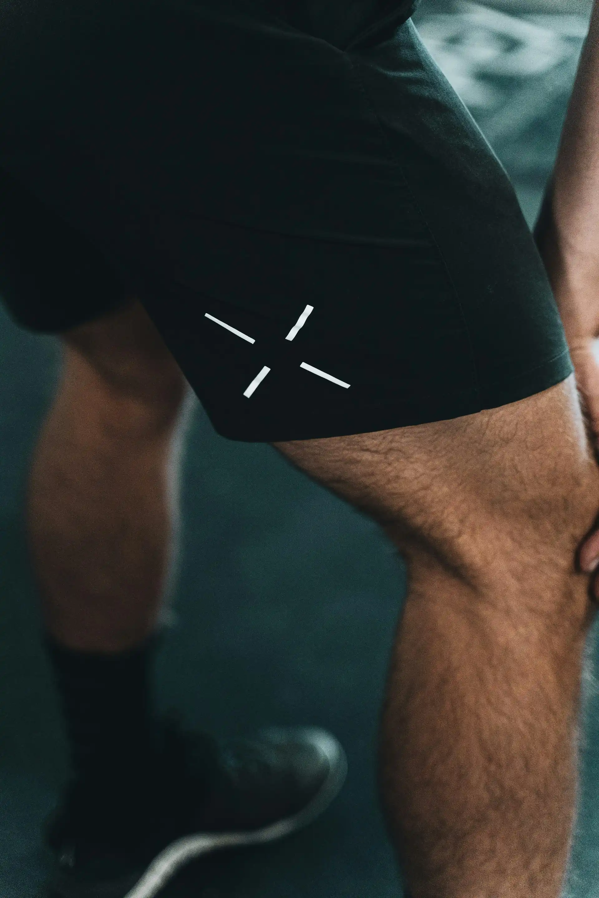 A man in black training shorts.