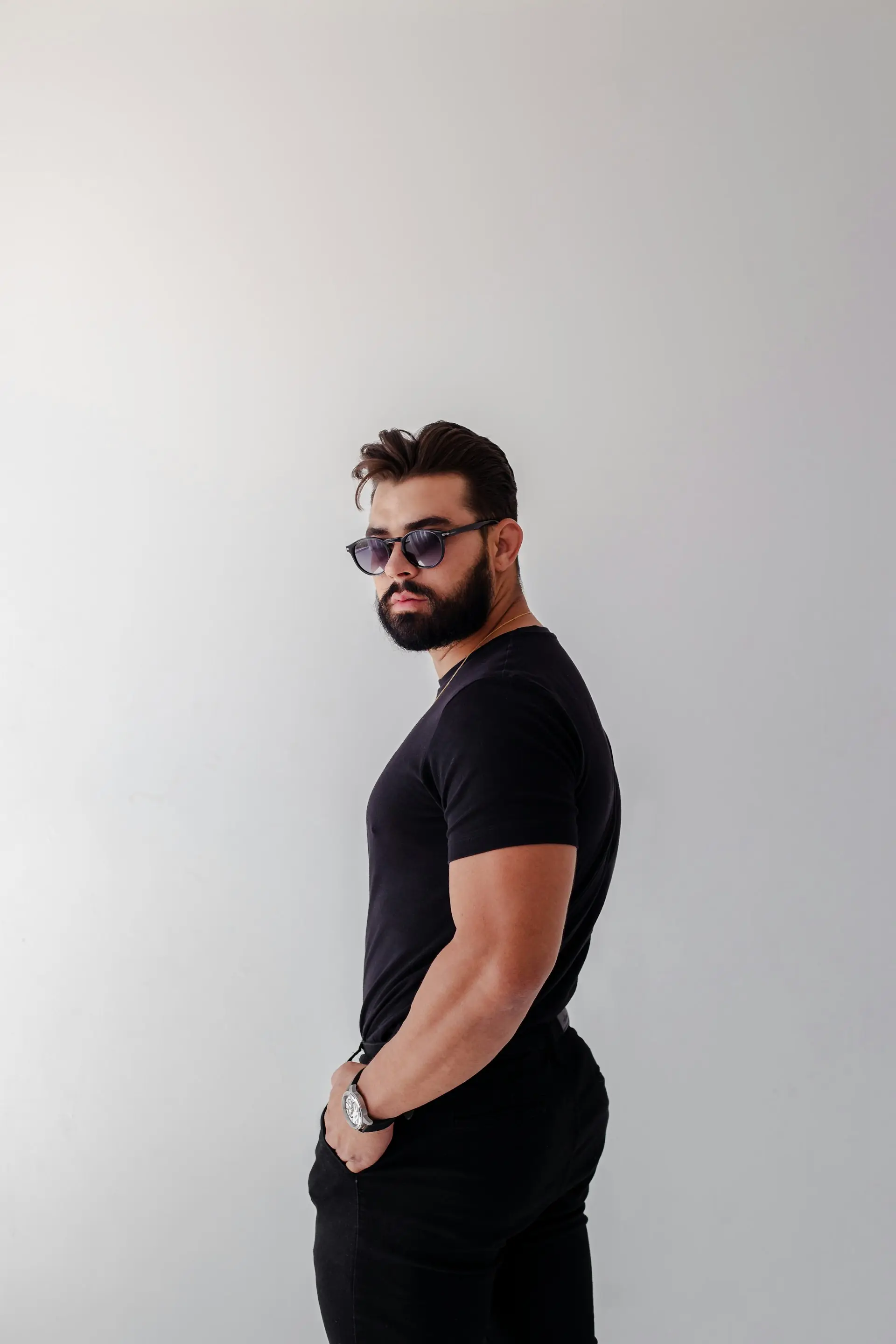 A man in sunglasses and a black tee.