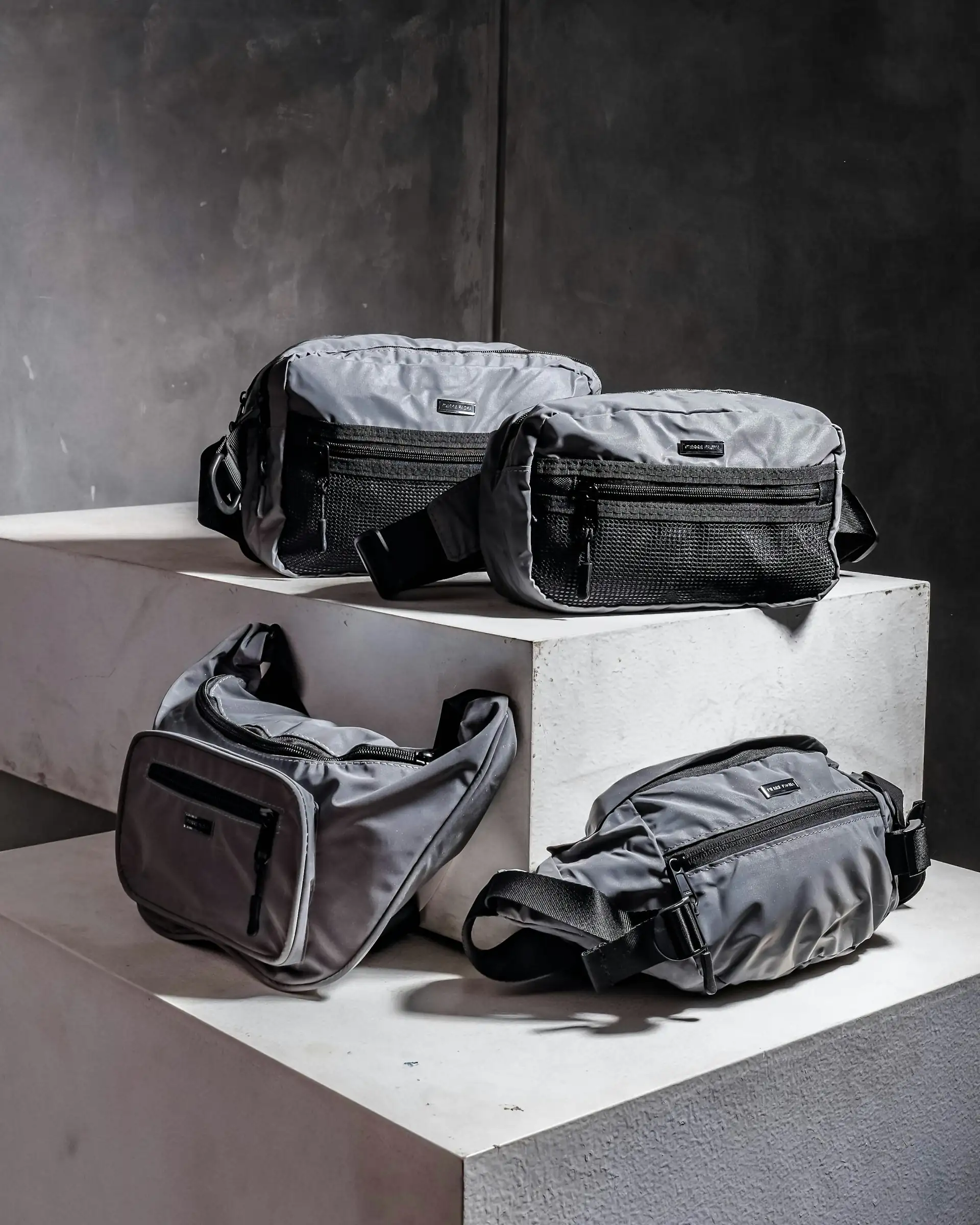 Run pouches staged on concrete blocks against a dark wall.