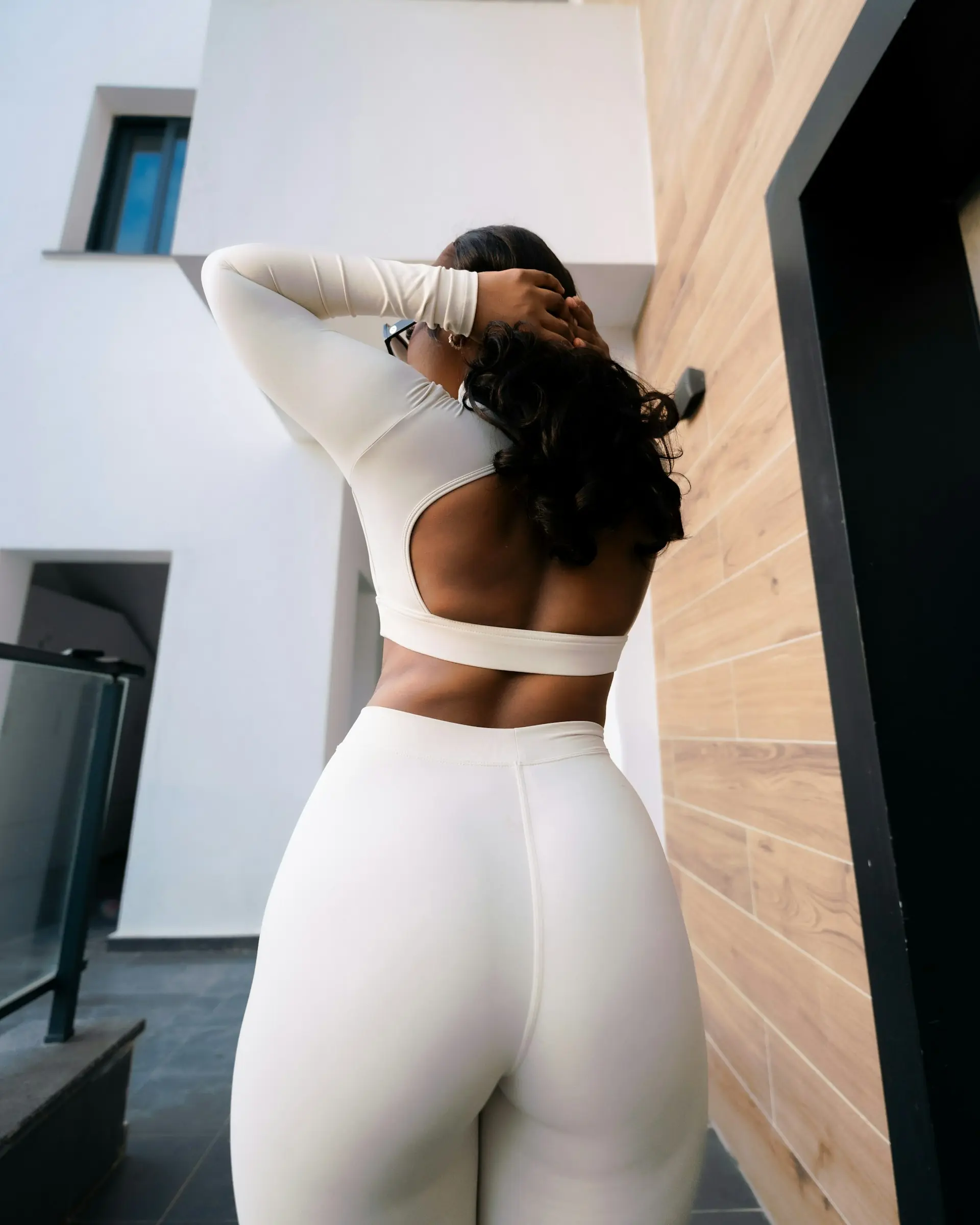 A woman in white athletic wear, easy light.