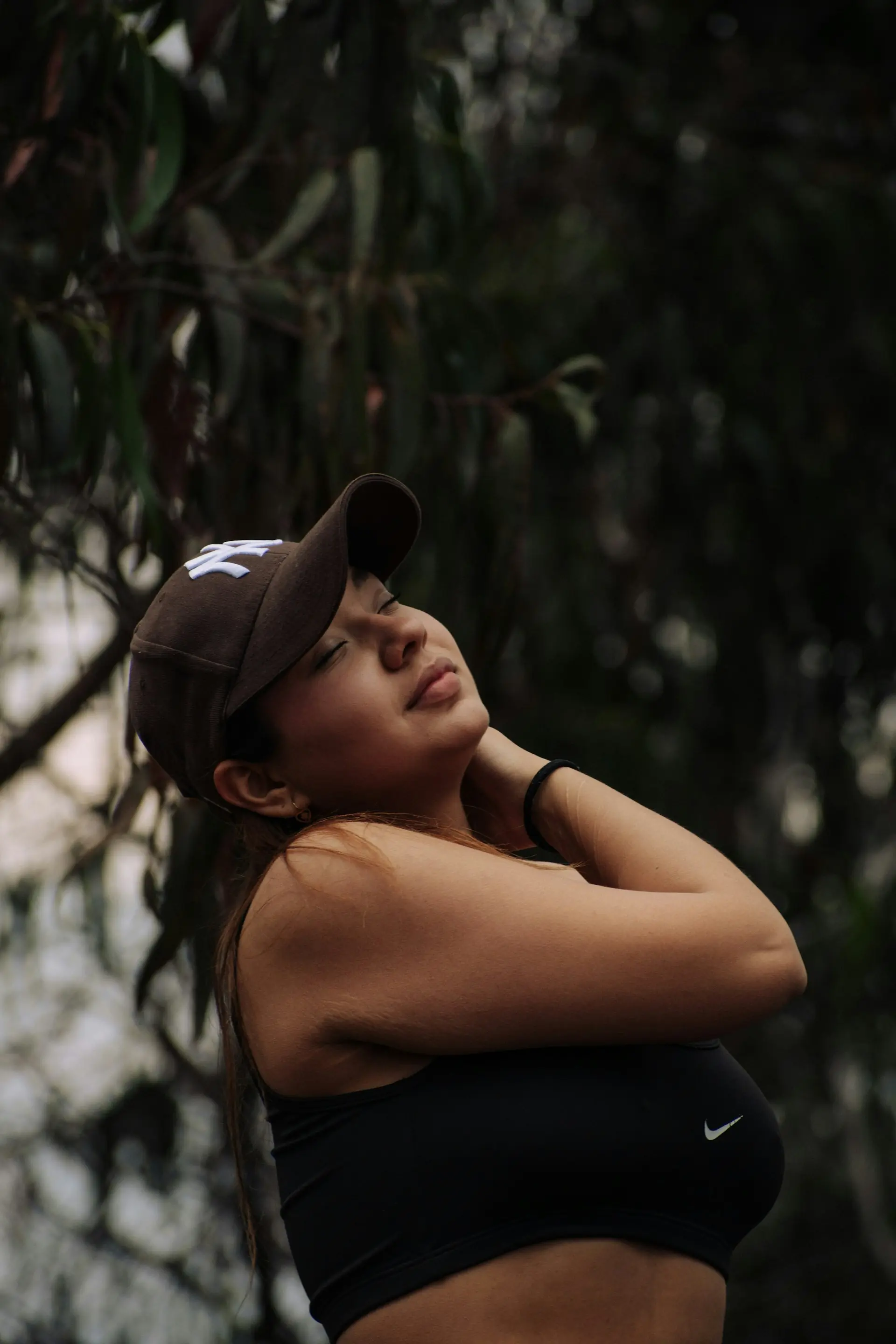 A runner in a cap and sports bra.