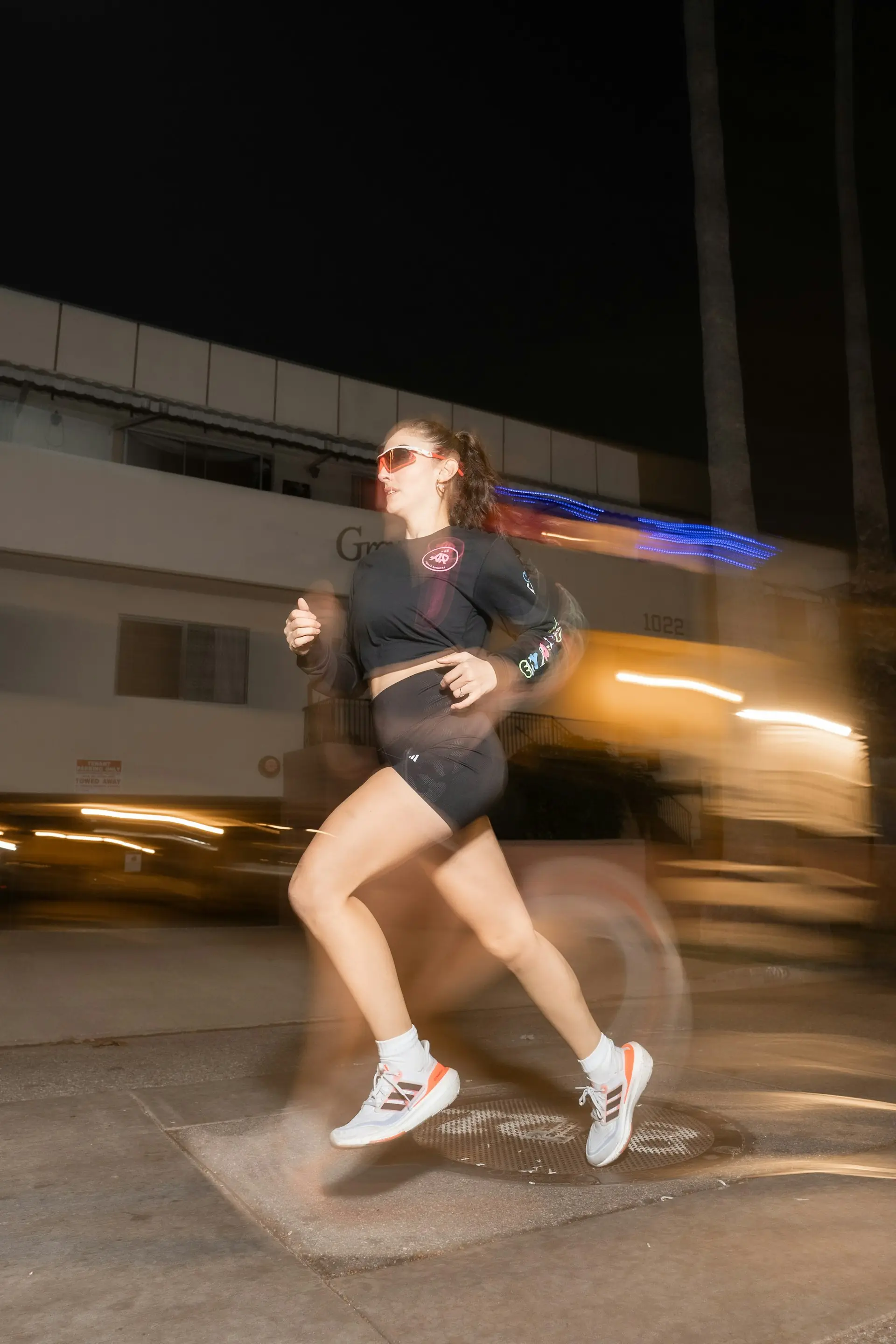 A woman running through the city at night.